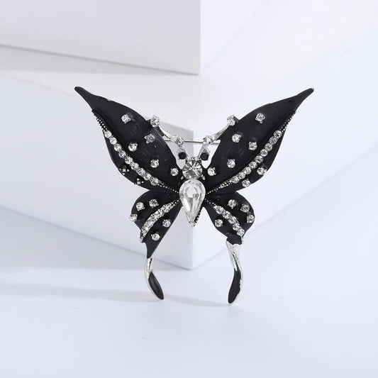Brosa Leona, neagra, cu montura argintie, in forma de fluture